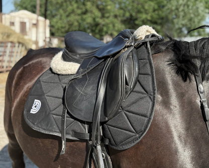 Vela air mesh saddle pad in Obsidian placed under saddle on horse